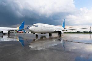 Airplanes at the airport reflected in a puddle. Air transport. Flights and travel. Plane apron photo