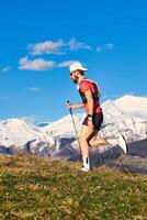 Young sporty man practices nordic walking photo