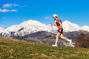 Young sporty man practices nordic walking photo