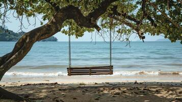 AI generated A wooden bench swing hanging from the branch of an old tree on a beach photo