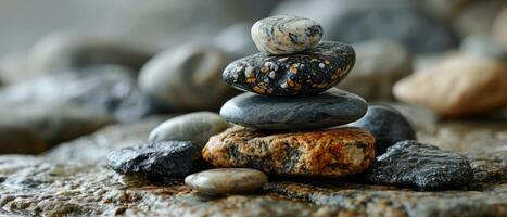 ai generado un cuidadosamente equilibrado apilar de variado piedras, simbolizando estabilidad y tranquilidad, en un áspero rocoso superficie foto