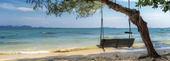 AI generated A wooden bench swing hanging from the branch of an old tree on a beach photo