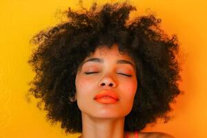 AI generated Close-up of a woman with voluminous curly hair and freckles, eyes closed, basking in the sunlight against a vivid yellow background photo