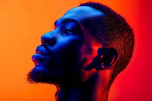 AI generated A portrait of a man lost in thought, his profile highlighted by a striking orange and blue light, creating a thoughtful mood photo