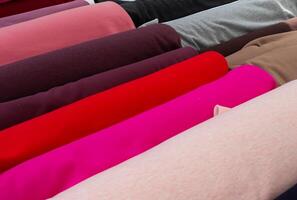 Detailed close up view on samples of cloth and fabrics in different colors found at a fabrics market photo