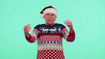 Grandfather man in sweater Christmas Santa shouting, celebrating success, winning, goal achievemen video