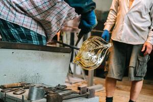 The process of making glass decor with glassblowers photo