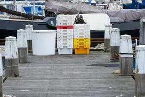 Fish boxes in the harbor at the jetty photo