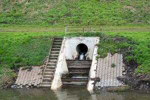 Industrial wastewater flows into sewer photo