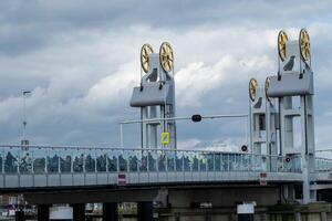 many cyclists waiting on the lift bridge in kampen, the netherlands photo