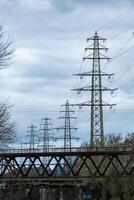 high voltage pylon in front of a cloudy sky photo