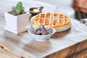 chocolate ice cream or a cup of chocolate ice cream and waffle on the table photo