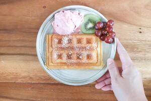 waffle with ice cream and fruit or strawberry ice cream with waffle, grape and kiwi fruit photo