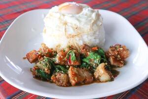 stir fried pork with basil and rice , sunny side up egg or stir fried bacon with basil photo