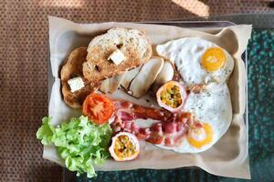 toast with bacon, fried egg and lettuce or sunny side up egg with bacon and  mushroom photo