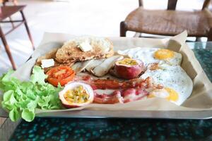 toast with bacon, fried egg and lettuce or sunny side up egg with bacon and  mushroom photo