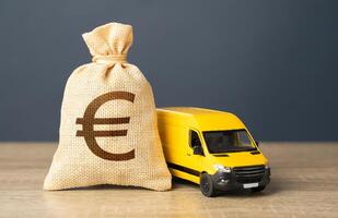 Delivery van and euro money bag. Invest in electric and autonomous vehicles. Freight transportation. Logistics industry, driver shortages. Supply chain resilience. photo