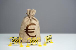 Euro money bag is fenced with barriers. Capital restrictions. Limiting the amount of money flowing in or out. Limit investment opportunities. Prevent rapid fluctuations in exchange rates. photo