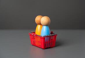 Buyers are sitting in a shopping basket. Buyer preferences. Market basket research. Gain insight into the hearts and minds of consumers. Products and marketing strategies photo