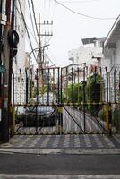 residential fence gate with barbed wire. surabaya, indonesia - 21 february 2024 photo