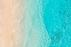 Aerial view of sandy beach and ocean nature with waves. Beach and waves from top view. Turquoise water background. Summer seascape from air. Aerial drone landscape. Travel vacation concept and idea photo