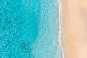 Aerial view of sandy beach and ocean nature with waves. Beach and waves from top view. Turquoise water background. Summer seascape from air. Aerial drone landscape. Travel vacation concept and idea photo