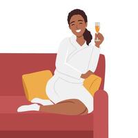 Young beautiful smiling woman sitting with bent legs on a large comfortable sofa with cup of tea or drink vector