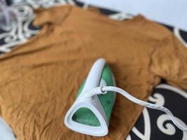 Ironing men's clothes and giving them clothes freshener to make them fragrant and smooth photo