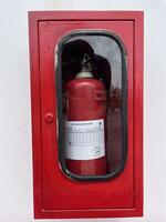 The red tube fire extinguisher contains dry chemical powder to separate the oxygen that causes fires photo