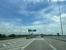 Highways in Indonesia with bright, dark and cloudy skies in the background photo