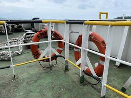 The ship's ring buoy hangs on the iron railing for emergencies if an accident occurs photo