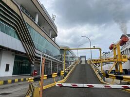 Yellow ship bridge with black yellow lines and car parking space inside the ship photo