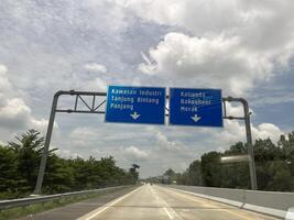 Highways in Indonesia with bright, dark and cloudy skies in the background photo