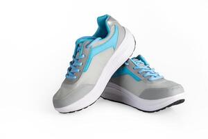 A pair of new blue gray women's sneakers running shoes isolated on white background. photo