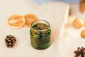 Jar with honey tincture of forest pine needles. Means and medicines of folk medicine photo