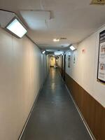 The passenger ship lobby hallway of the ship's VIP room with lights and posters on the walls photo