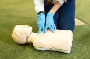 Cpr training in class. Reanimation procedure on CPR doll photo