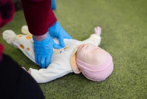 CPR training on an infant training manikin photo