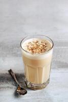 coffee with milk and grated nut in a glass close-up. Raff coffee photo