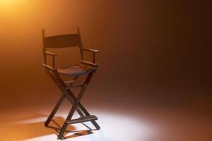 The director's chair stands in a beam of light with an orange backlight and smoke. Place for text. Free chair. Concept of selection and casting. Shadow and light. photo