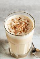 coffee with milk and grated nut in a glass close-up. Raff coffee photo