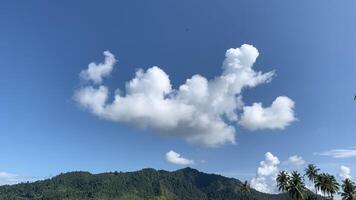 A view of the blue sky and uniquely shaped clouds photo