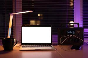 Charging station for laptop and desk lamp when there is no light during blackout. Generator power bank battery in the absence of electricity. at home table photo