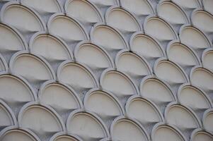 Element of decoration of the facade of a building. Texture of gray marble pattern with round elements. photo