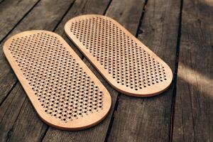 Sadhu board on wood background. The practice of standing on nails. Yoga concept. photo