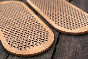 Sadhu board on wood background. The practice of standing on nails. Yoga concept. photo