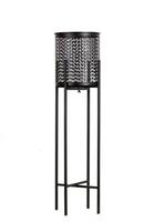 Black tall metal openwork planter on a stand, flower pot isolated photo