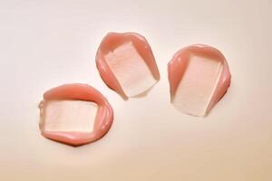 Texture of a pink nourishing lip mask. photo