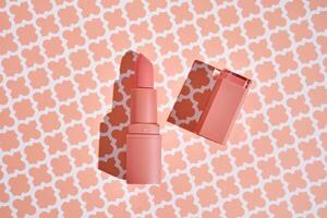 Peach lipstick on a peach background. photo