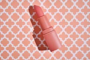 Peach lipstick on a peach background. photo